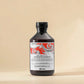Bouteille de shampooing énergisant Davines Naturaltech sur fond beige