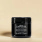 Pot noir de Davines OI Hair Butter sur un fond beige