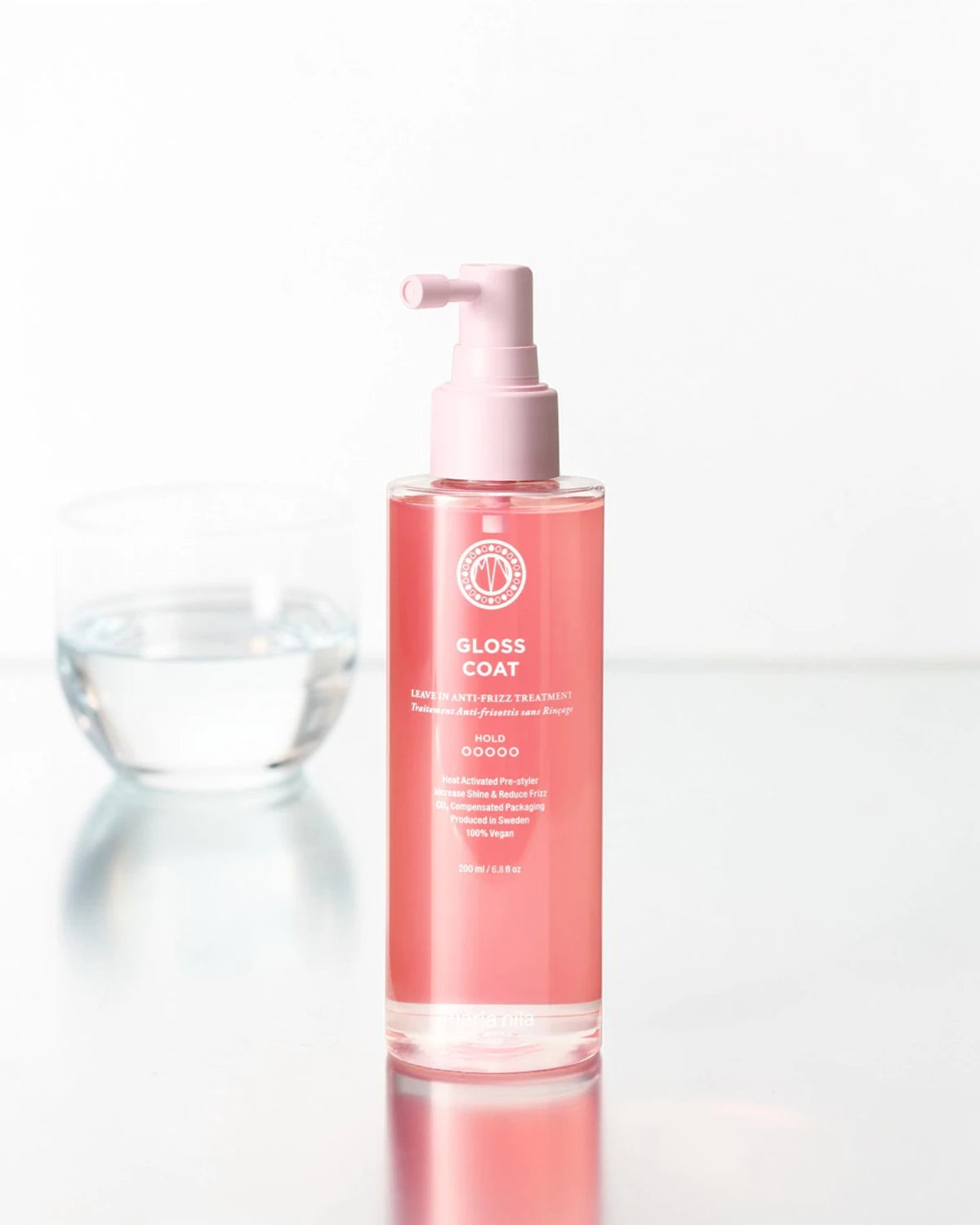 Bouteille de produit 'Gloss Coat' sur fond blanc