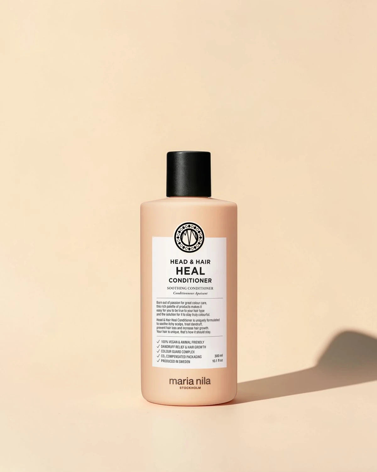 Maria Nila head & hair heal conditioner flacon sur un fond beige