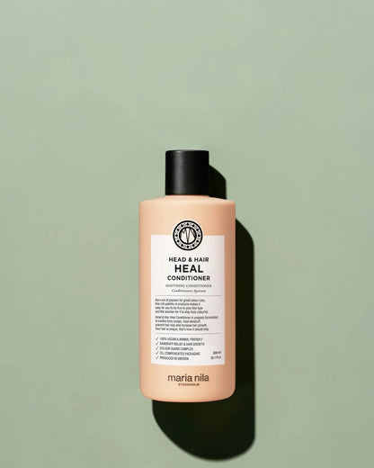 Maria Nila head & hair heal conditioner flacon sur un fond vert