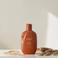 Shampoing Urban Alchemy Repair Radiance sur fond beige avec épis de blé, Victor Bazin Paris