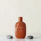 Shampoing Urban Alchemy Repair Radiance sur fond beige avec épis de blé, Victor Bazin Paris